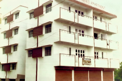 Left side view of Naseeb Apartments with shops